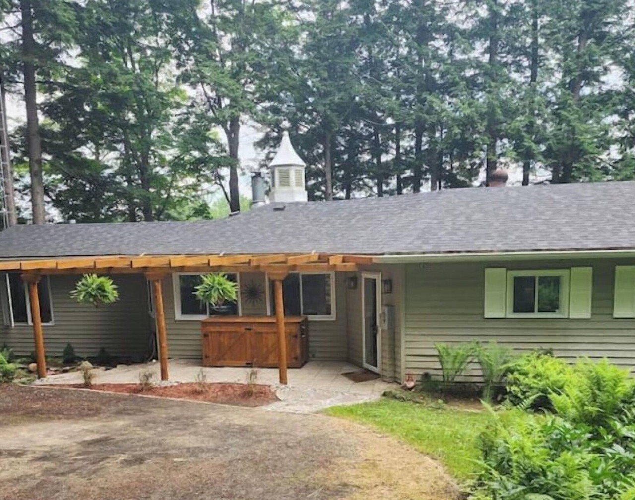 Spacious, waterfront home surrounded by trees with large dock & games room. 1