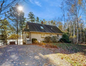 Charming riverfront home with cozy interiors, dock, and scenic deck views 4