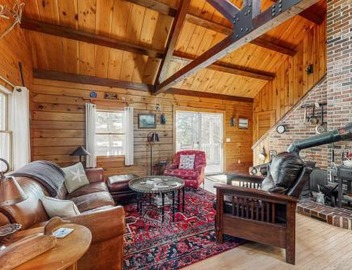 Charming riverfront home with cozy interiors, dock, and scenic deck views 5