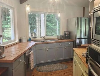 Spacious, waterfront home surrounded by trees with large dock & games room. 3