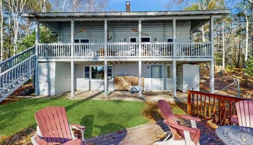 Charming riverfront home with cozy interiors, dock, and scenic deck views