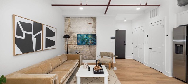 Design-forward flat in Old Town's most iconic building. Exposed brick, bold red ceiling pipes, corner bedroom bathed in natural light. Modern kitchen, quiet side street. Steps from 100+ restaurants & waterfront. A LovableBNB Collection listing.
