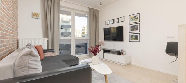 Subtle Colors Apartment in Warsaw with Furnished Balcony by Noclegi Renters